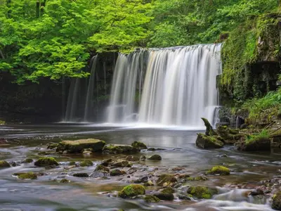 a waterfall in a river with rocks and trees at 2 Bed in Brecon oc-92729 in Brecon
