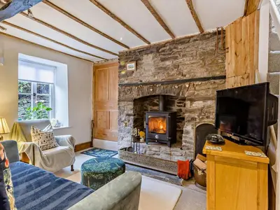 a living room with a large stone fireplace at 2 Bed in Brecon oc-92729 in Brecon