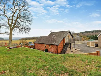 a brick building with a playground in a field at 2 Bed in Craven Arms oc-94099 in Clun