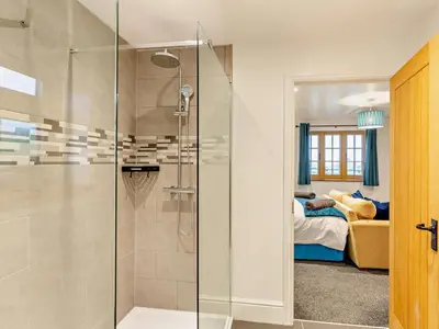 a bathroom with a glass shower and a bedroom at 2 Bed in Craven Arms oc-94099 in Clun