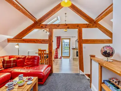 a living room with a red couch and a table at 2 Bed in Craven Arms oc-94099 in Clun