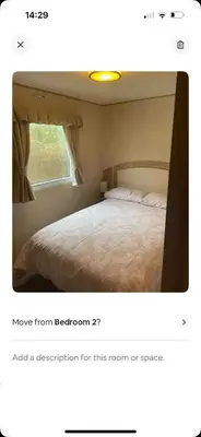 a screenshot of a bedroom with a bed and a window at AJ’s Caravan Hire in Aberystwyth