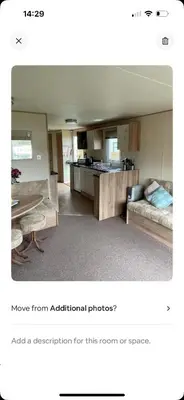 a living room with a couch and a table at AJ’s Caravan Hire in Aberystwyth