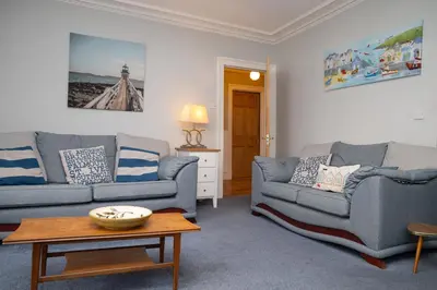 a living room with two couches and a coffee table at No. 1 Cliffside New Quay in New Quay