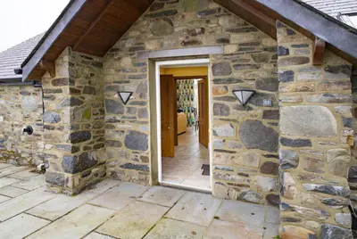 an entrance to a stone house with a doorway at Ty Cellin Tregaron in Ystrad-Meurig
