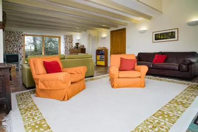 a living room with two chairs and a couch at Bryn Isaf Tregaron in Ystrad-Meurig