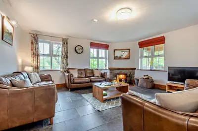 a large living room with couches and a tv at 4 Bed in Rhayader oc-m28919 in Nantmel