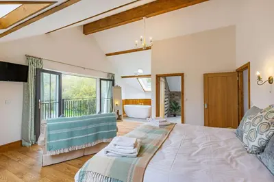 a bedroom with a large bed and a large window at 4 Bed in Rhayader oc-m28919 in Nantmel