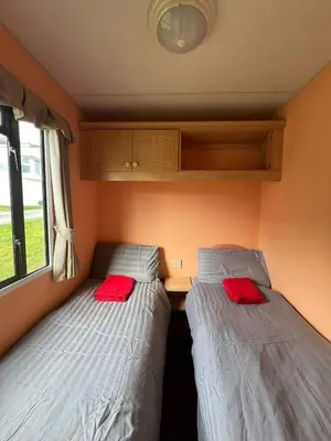 two beds in the corner of a room at Spacious 2 bedroomed mobile home in Aberystwyth