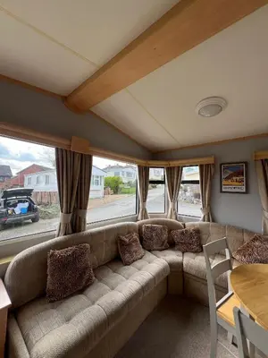 a living room with a couch and a table at Spacious 2 bedroomed mobile home in Aberystwyth