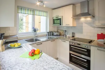 a kitchen with a bowl of fruit on a counter at Ellesmere New Quay in New Quay