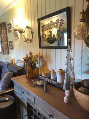 a living room with a table with a picture on the wall at Cabin in the hills near Dolgellau in Dolgellau