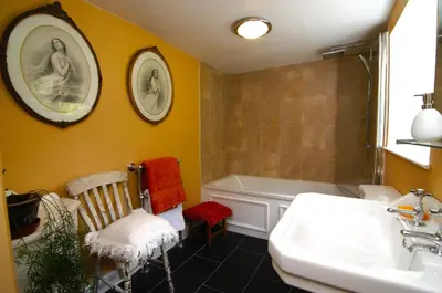 a bathroom with a sink and a shower and a tub at Cae Mawr Borth and Ynyslas in Scyborycoed