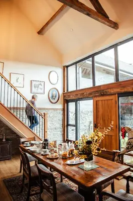 a dining room with a wooden table and chairs at The Granary Wales in Kington