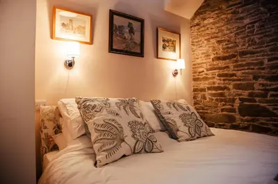 a bedroom with a bed with two pillows on it at The Granary Wales in Kington