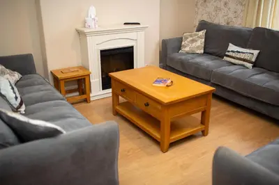 a living room with couches and a coffee table at Townhouse Aberystwyth in Aberystwyth