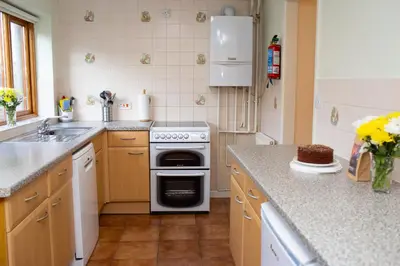 a kitchen with a stove and a sink at Townhouse Aberystwyth in Aberystwyth