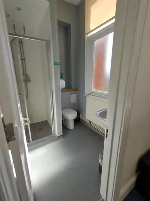 a bathroom with a toilet and a sink and a window at Kington Accommodation in Kington