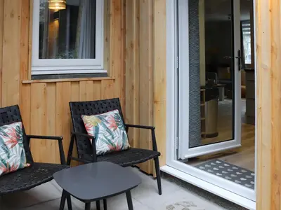 two chairs and a table on a porch at Llety Cariad in Bala