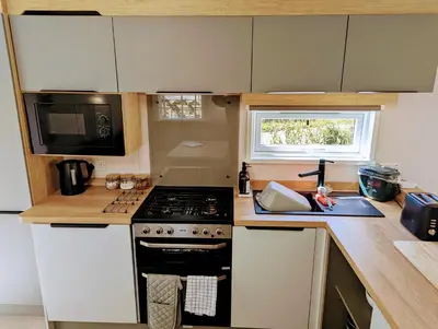 a kitchen with a stove and a microwave at Sarn Y Glyn in Mid Wales Cambrian Mountains near Llanidloes Powys in Caersws
