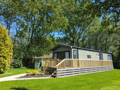 a tiny house in a yard with a deck at Sarn Y Glyn in Mid Wales Cambrian Mountains near Llanidloes Powys in Caersws