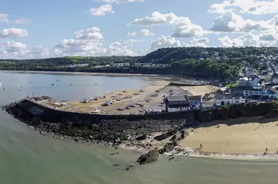 an aerial view of a beach with cars parked at Glenydd New Quay in New Quay