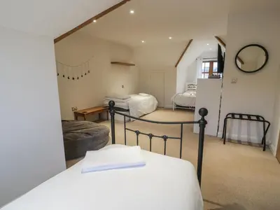 a bedroom with two beds in a room at Anadlu in Llanbedr