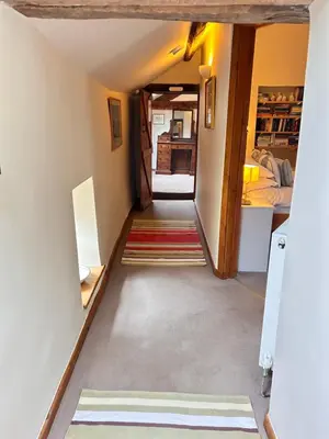 a hallway in a house with a hallway leading into a room at Llanerch in Bala