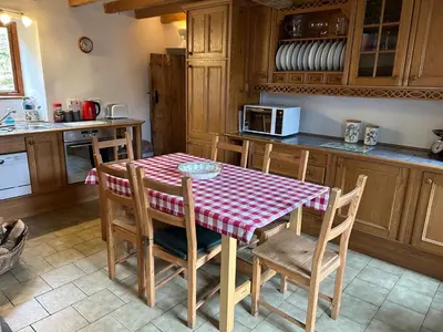 a kitchen with a table with a red and white checkered table cloth at Llanerch in Bala