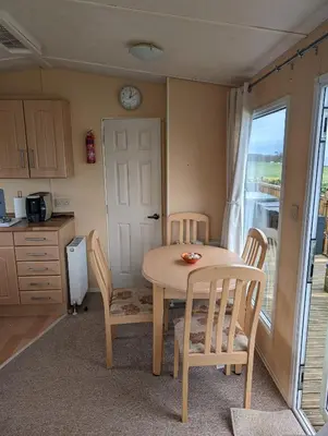 a kitchen with a table and two chairs and a table at 64 Wide Horizon in Aberaeron