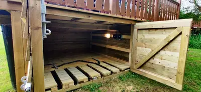 a wooden chicken coop with a door open at Serene Snowdonia Retreat in Trawsfynydd