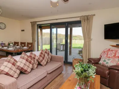 a living room with a couch and a table at Caban Dulas in Rhayader