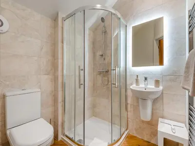 a bathroom with a shower and a toilet and a sink at Nupton Hop Kiln in Kings Pyon