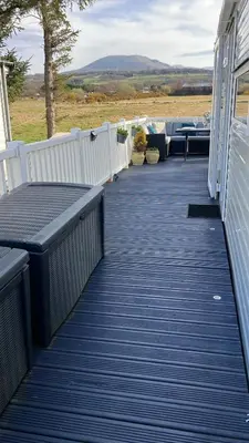 a deck with a bench on a house at Barmouthbay209 in Barmouth