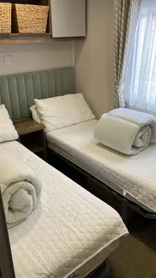a room with two beds and a window at Barmouthbay209 in Barmouth