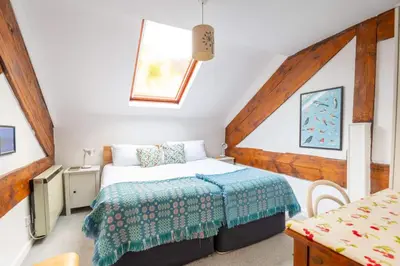 a small bedroom with a bed and a table at Ty'r Adar at Graig Wen in Arthog