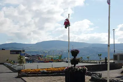 a flag on a pole in front of a playground at Abermaw Sea View Apartment in Barmouth