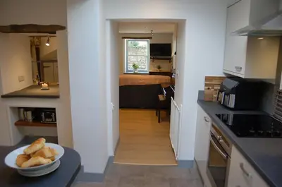 a kitchen with a bowl of bread on a counter at Ty Del - Beautiful Home in Tywyn in Tywyn