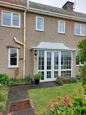 a house with a conservatory with a roof at Garreg Wen - White Stone, family holiday home in Barmouth