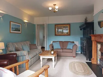 a living room with two couches and a coffee table at Garreg Wen - White Stone, family holiday home in Barmouth