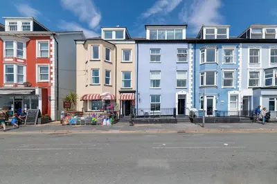 a row of buildings on a city street at Ground Floor Sea View Apartment in Aberdyfi