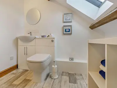 a bathroom with a toilet and a sink and a mirror at 2 Bed in Llanwrtyd Wells 94009 in Beulah