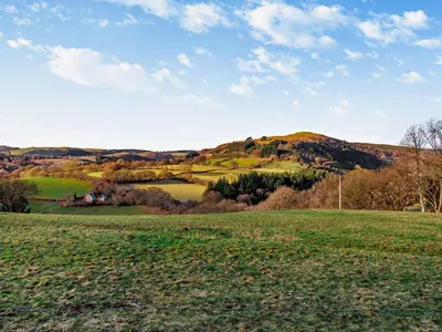 a green field with a hill in the background at 2 Bed in Llanwrtyd Wells 94009 in Beulah