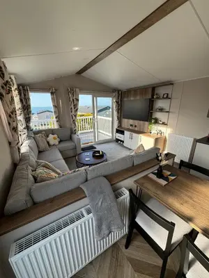 a living room with a couch and a table at Sea La Vie Lodge in New Quay