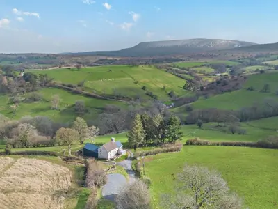 an aerial view of a farm in a green field at 3 Bed in Brecon oc-94434 in Velindre