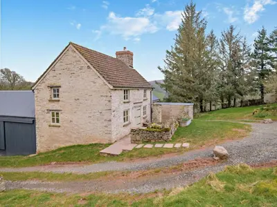 an old stone house on a hill with a driveway at 3 Bed in Brecon oc-94434 in Velindre