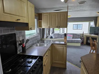 a kitchen with a sink and a stove top oven at Seaside View Holiday Home in Aberystwyth