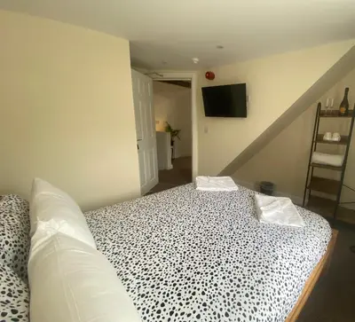 a bedroom with a bed with a black and white pattern at Prince of wales pub and accommodation in Llangollen