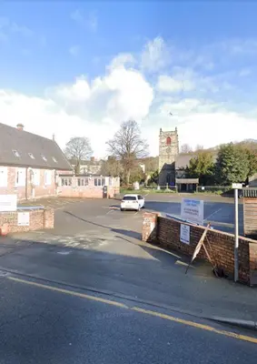 a car parked in a parking lot next to a building at Prince of wales pub and accommodation in Llangollen