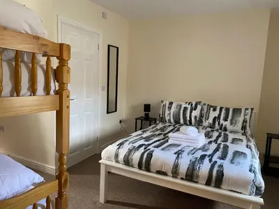 a bedroom with a bed and a bunk bed at Prince of wales pub and accommodation in Llangollen